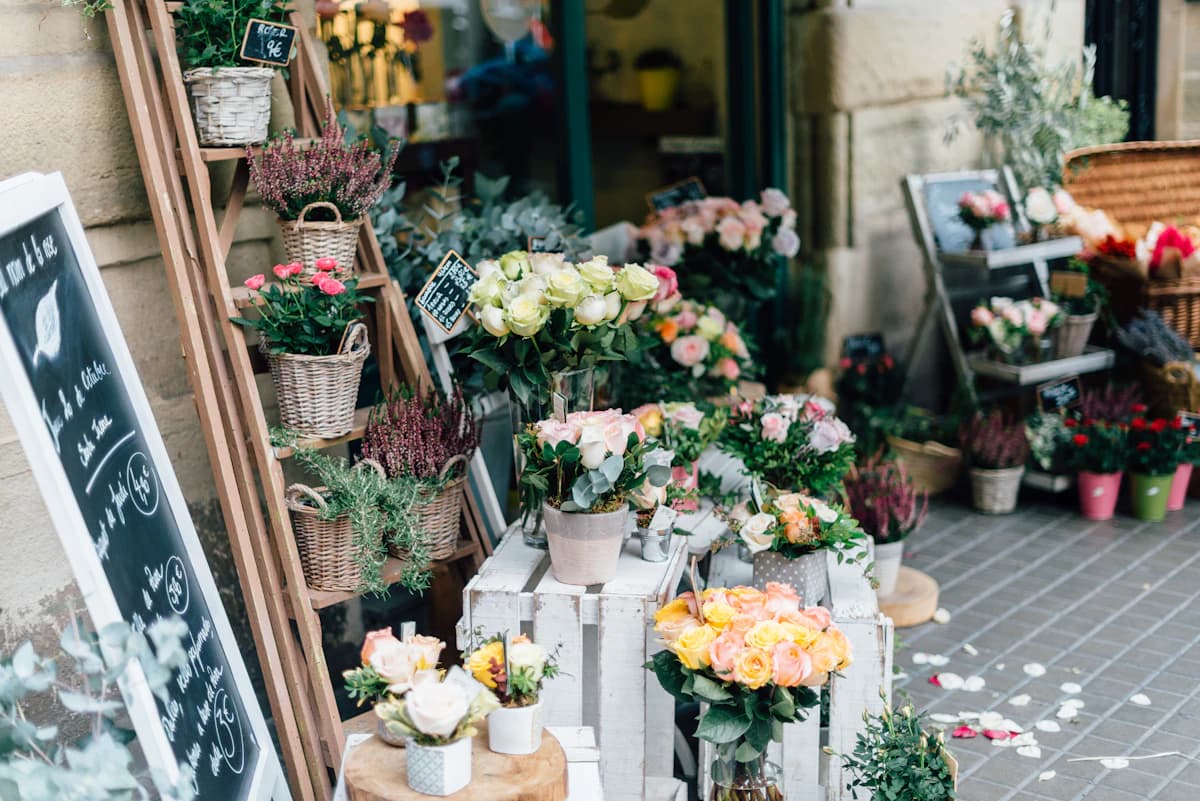 Buckets of fresh flowers outside a small flower shop